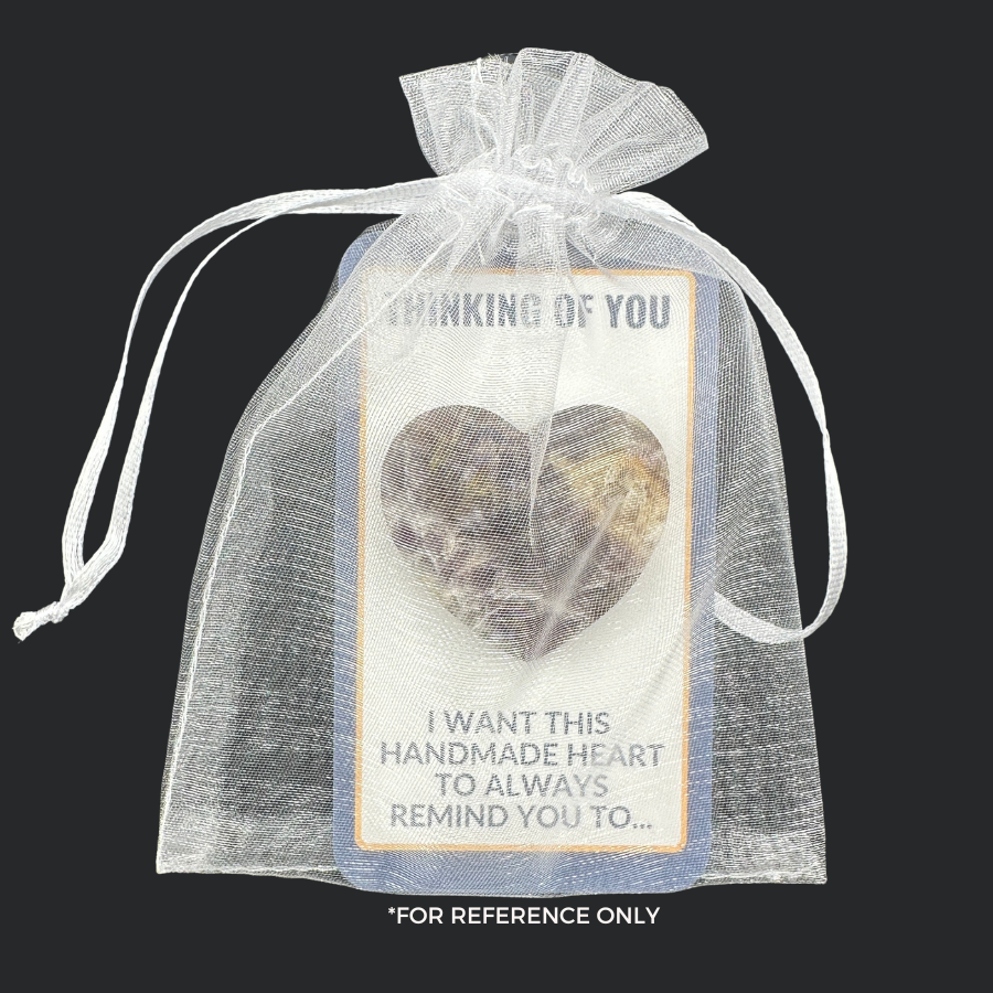 Heart-shaped stone affixed to an Affirmations Card, in a white organza bag.
